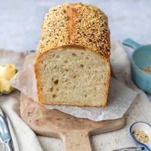 Sourdough Sandwich Bread, sliced, on a wooden board