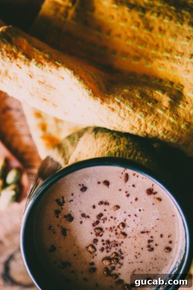 15 Decadent Cacao Delights 15 a cozy mug of hot cacao with cardamom and tahini, garnished beautifully for a comforting beverage