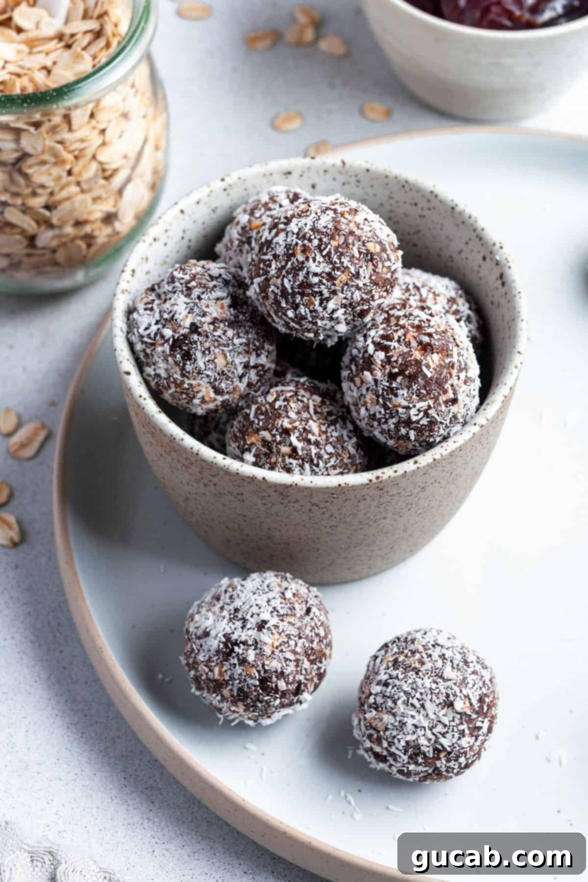 15 Decadent Cacao Delights 9 a plate of chocolate bliss balls, generously rolled in shredded coconut for a delightful texture and appearance