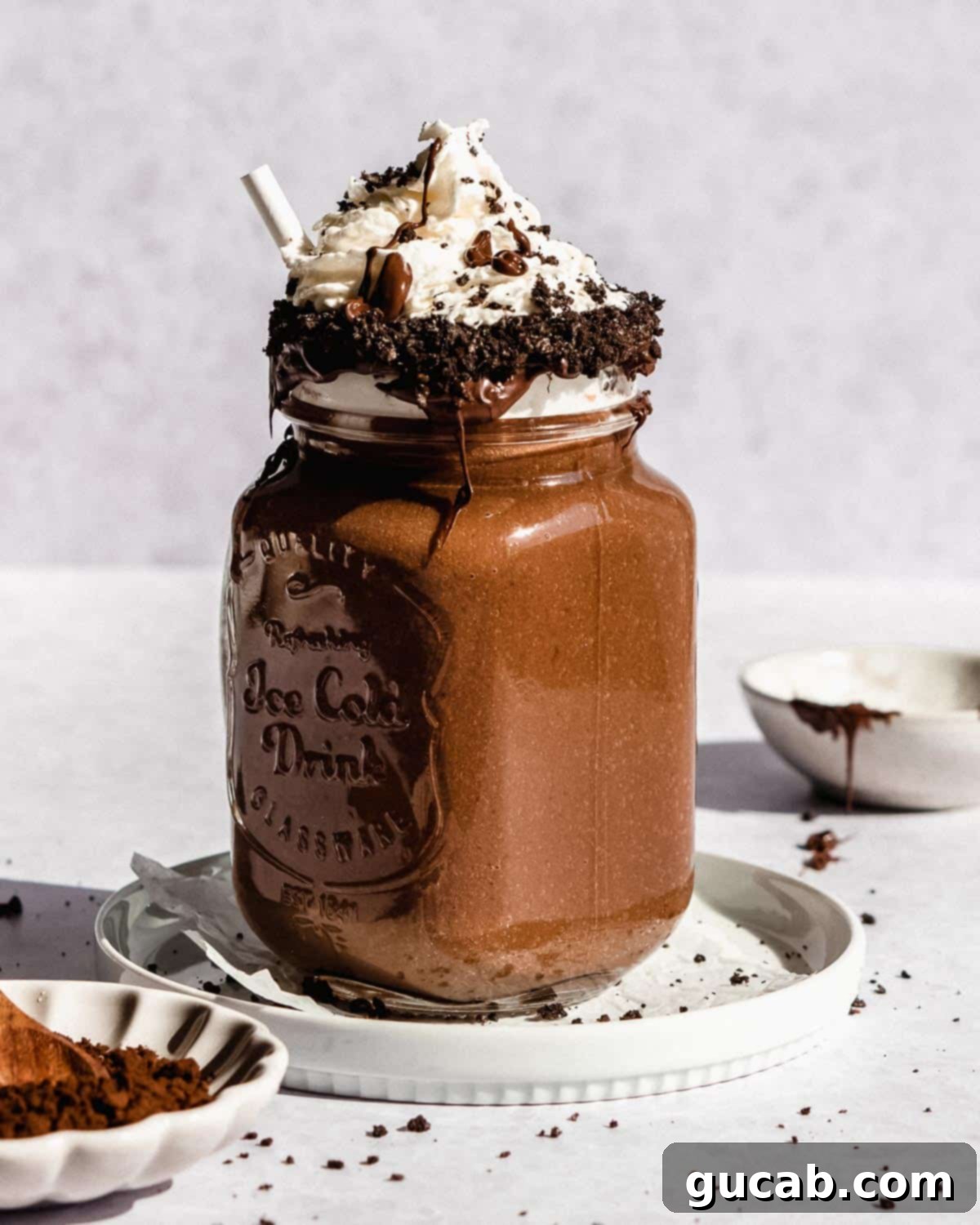 15 Decadent Cacao Delights 10 a decadent chocolate milkshake topped with a generous swirl of whipped cream and a sprinkle of chocolate shavings