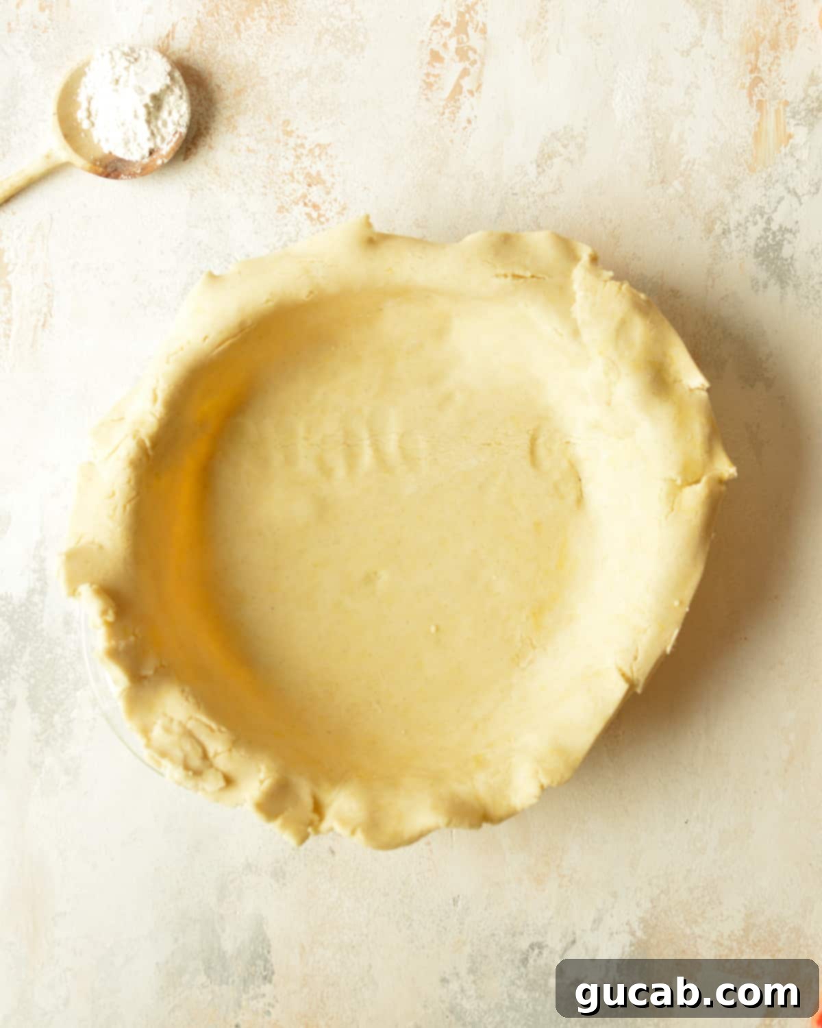 Gluten-free pie dough carefully placed into a pie pan.