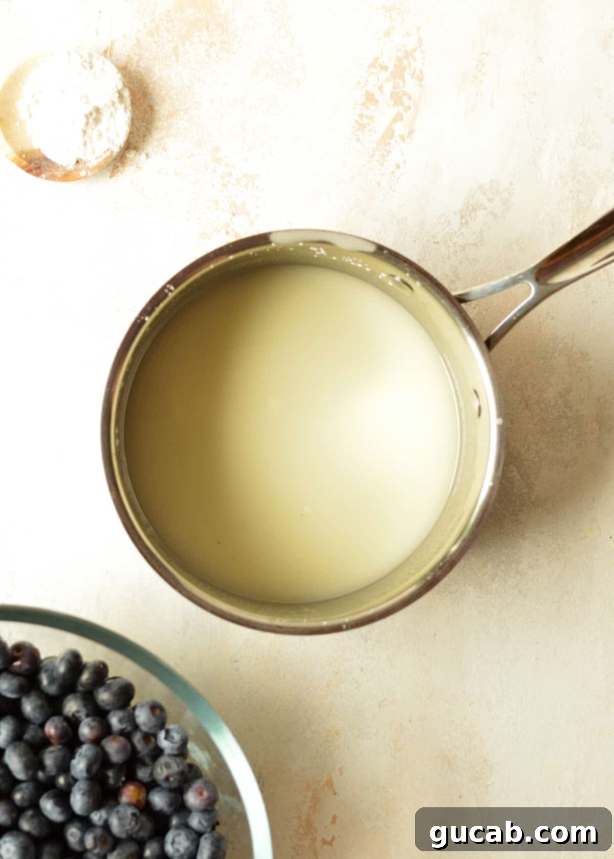 Ingredients for the blueberry pie slurry - cornstarch, water, sugar, and lemon juice mixed in a saucepan.