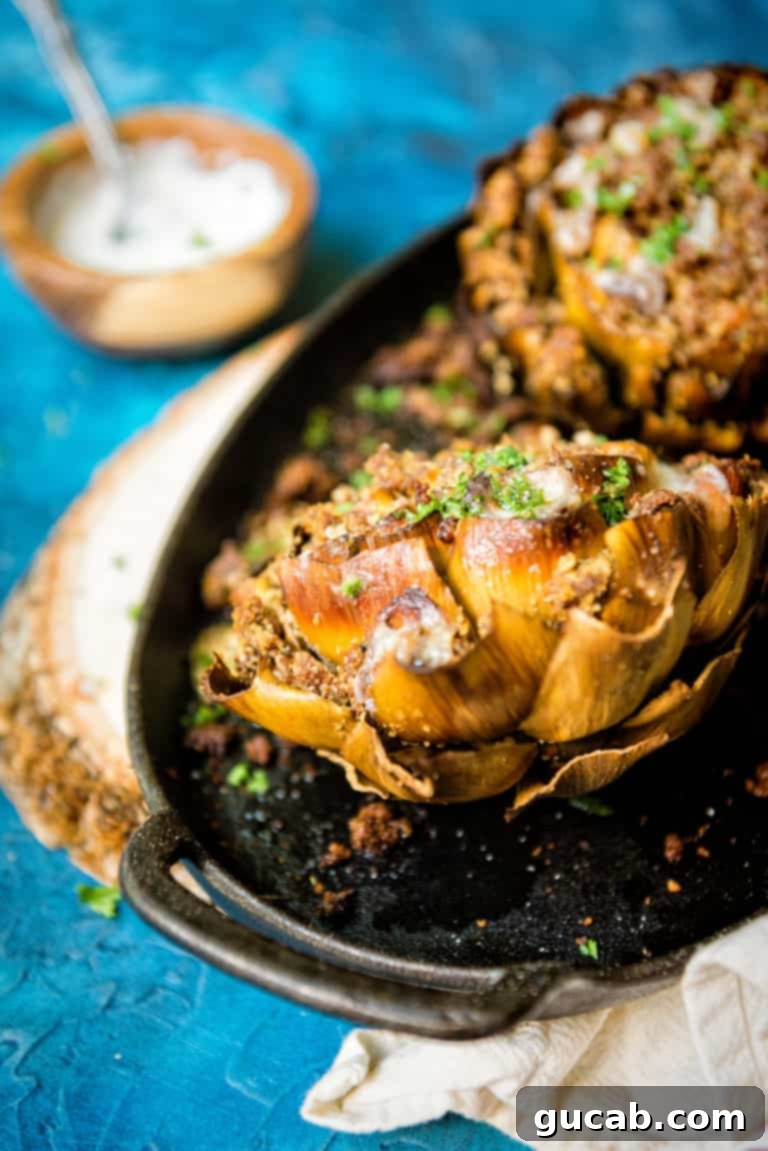 a cooked artichoke filled with breadcrumbs and smoked sausage