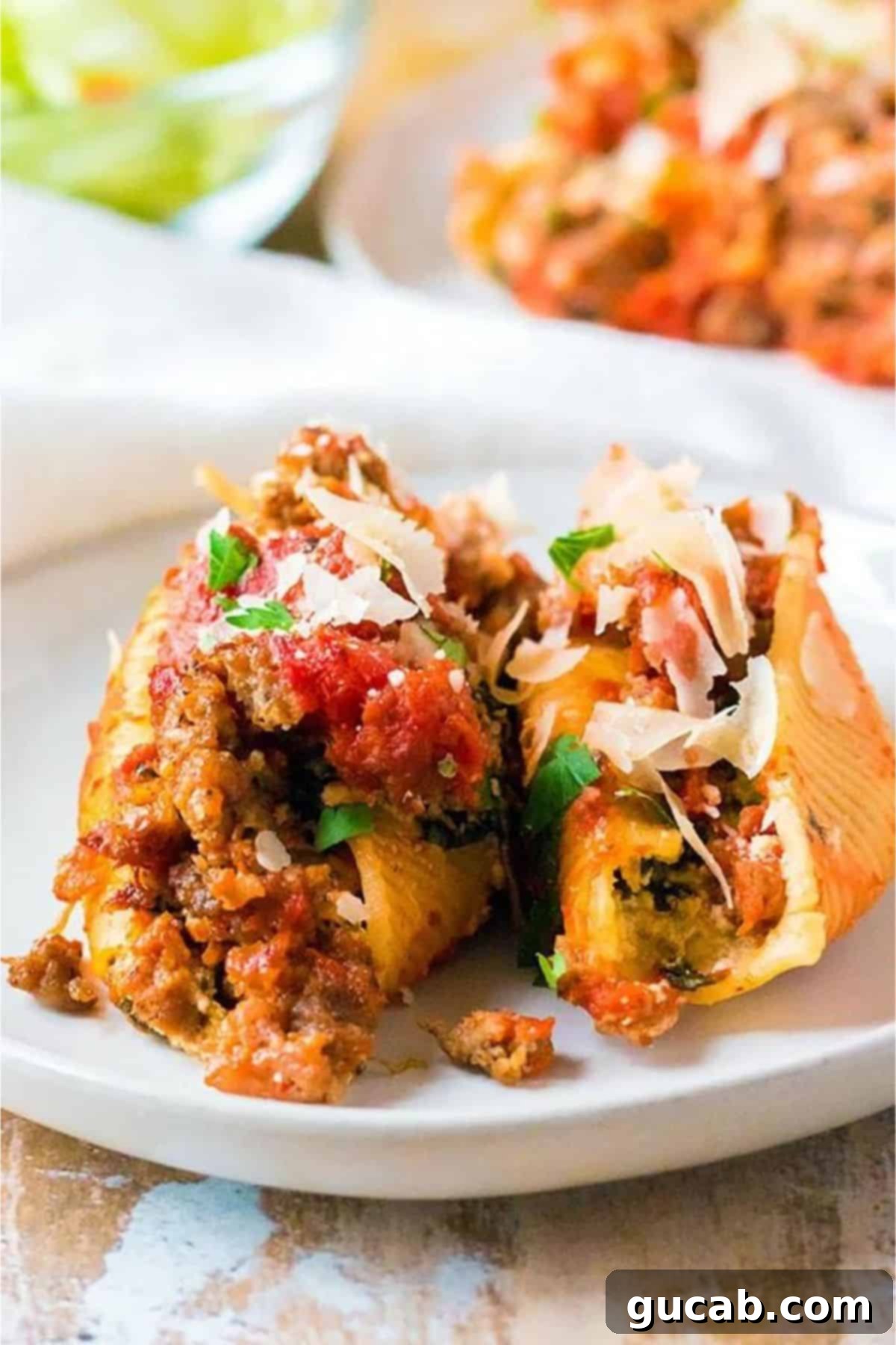 jumbo pasta shells stuffed with cheese and spinach, topped with sausage sauce