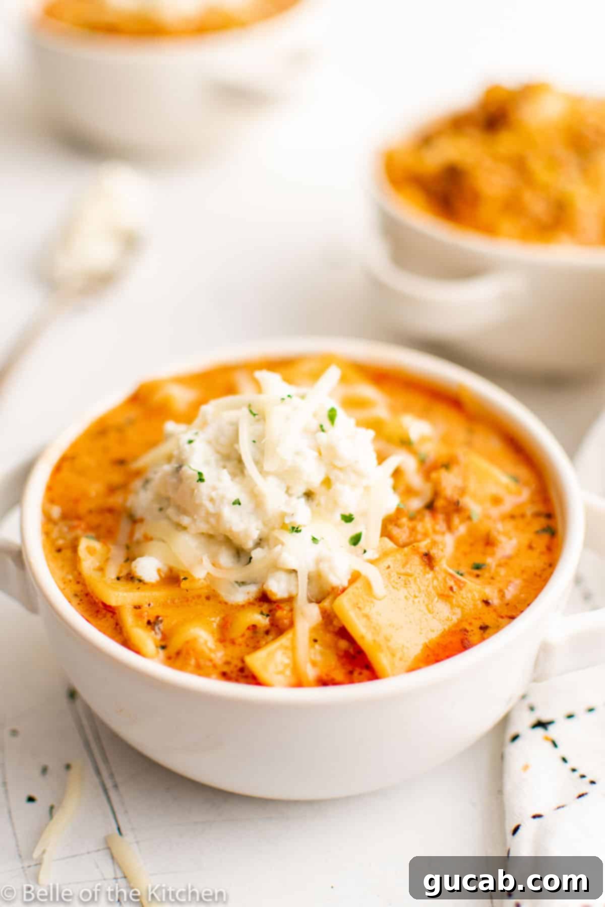 a bowl of Instant Pot lasagna soup topped with a dollop of ricotta cheese
