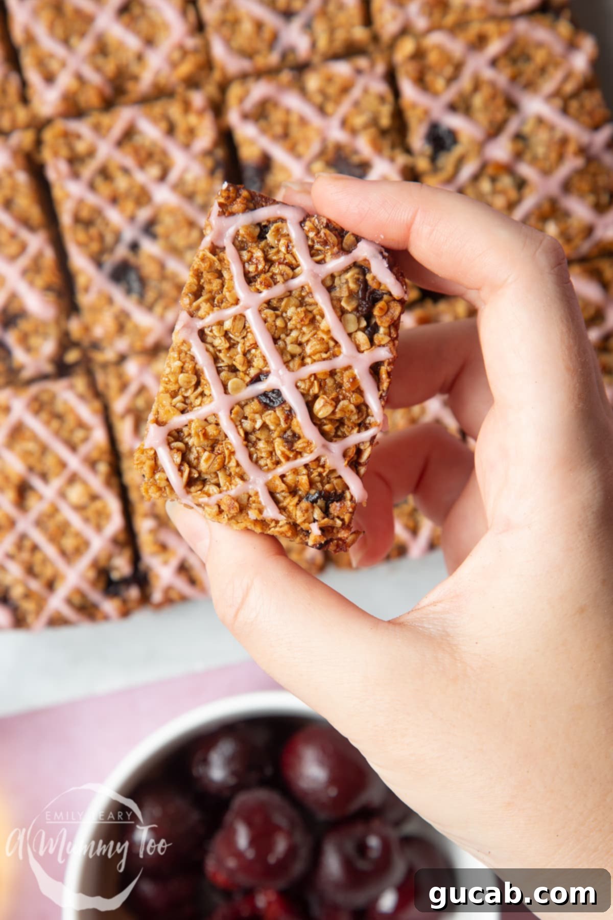 Beyond the Bowl: Creative Frozen Cherry Recipes 18 hand holding a cherry oat bar