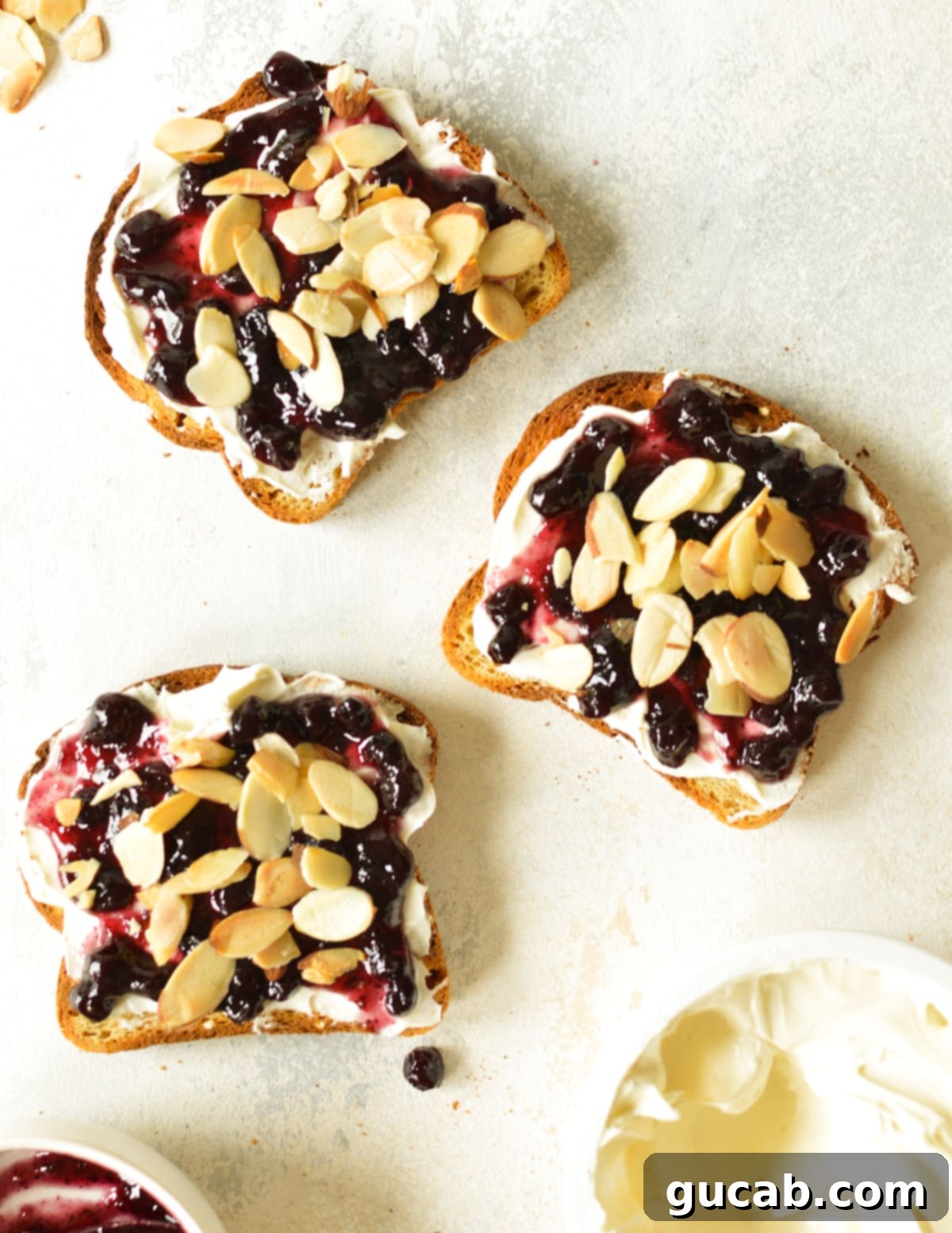 cream cheese, blueberry jam, and almonds on toast