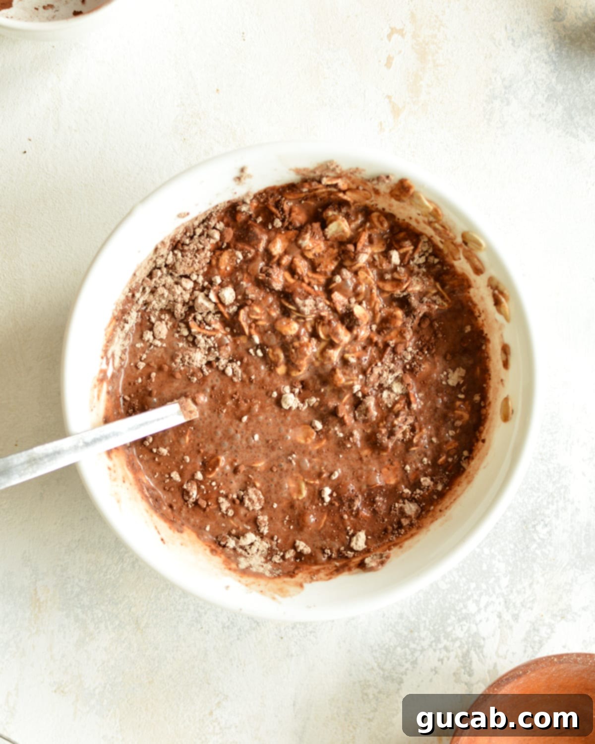 High Protein Overnight Oats 5 a bowl of oats mixed with chocolate and milk