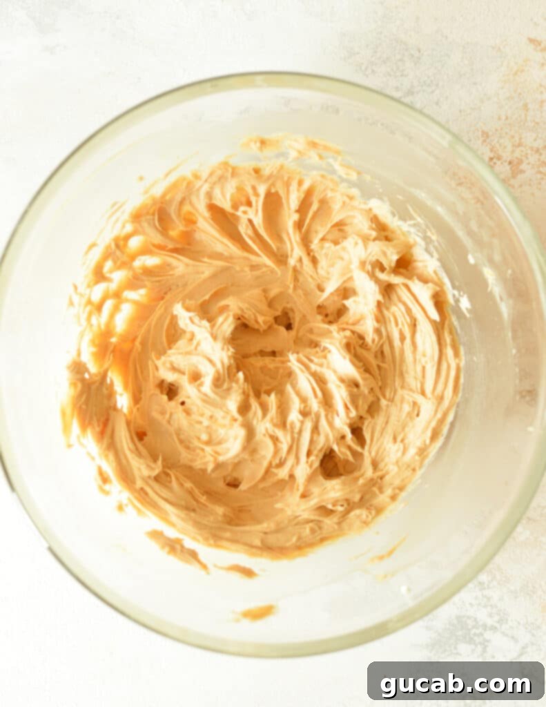 The butter, cream cheese, peanut butter, and vanilla mixture beaten until smooth and fluffy, ready for powdered sugar.