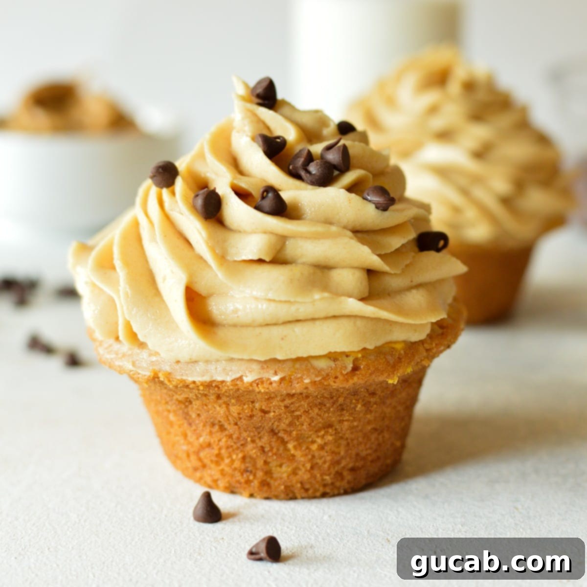 A beautifully frosted cupcake with swirls of peanut butter cream cheese frosting, showcasing its smooth and pipeable texture.