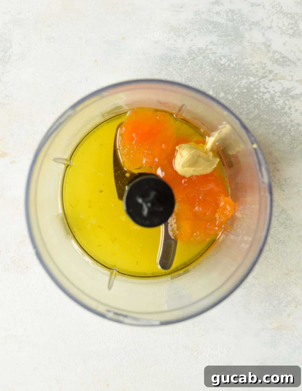 food processor with dijon mustard, lemon juice, and apricot jam