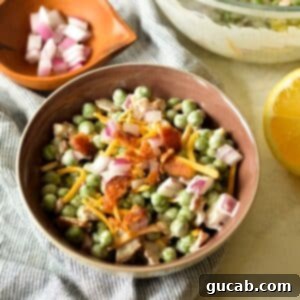 A bowl of creamy English pea salad with bacon and cheese, a perfect Southern side dish.