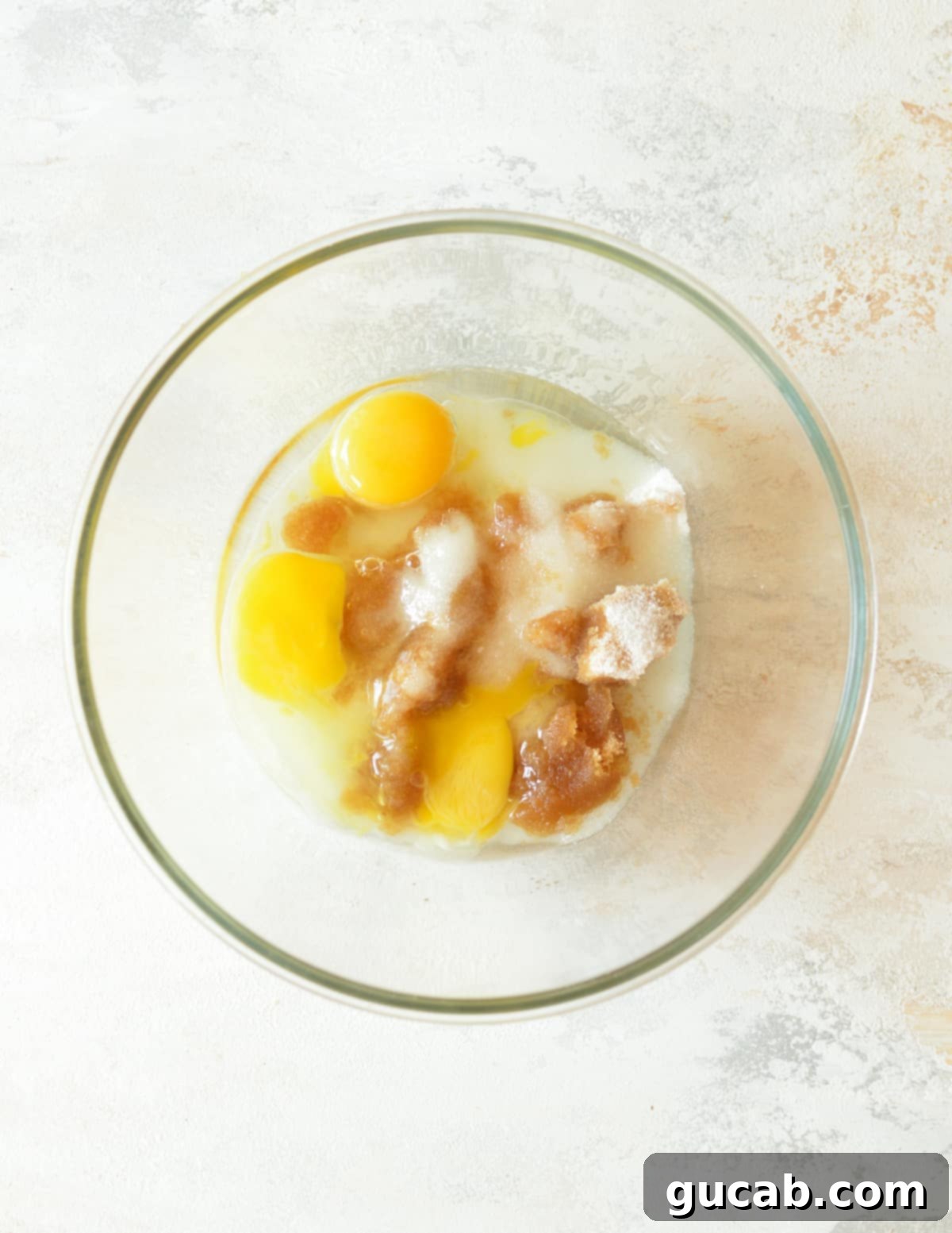 a bowl of sugar, oil, and eggs