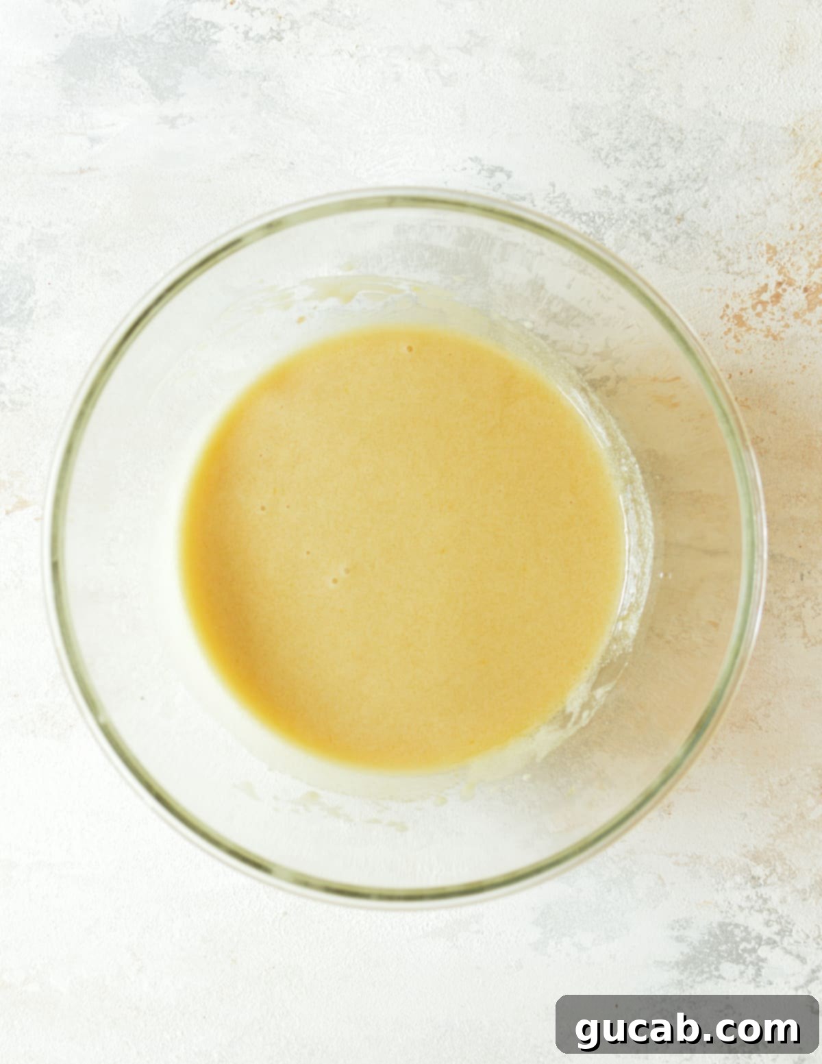a bowl of creamed oil, sugar, and eggs