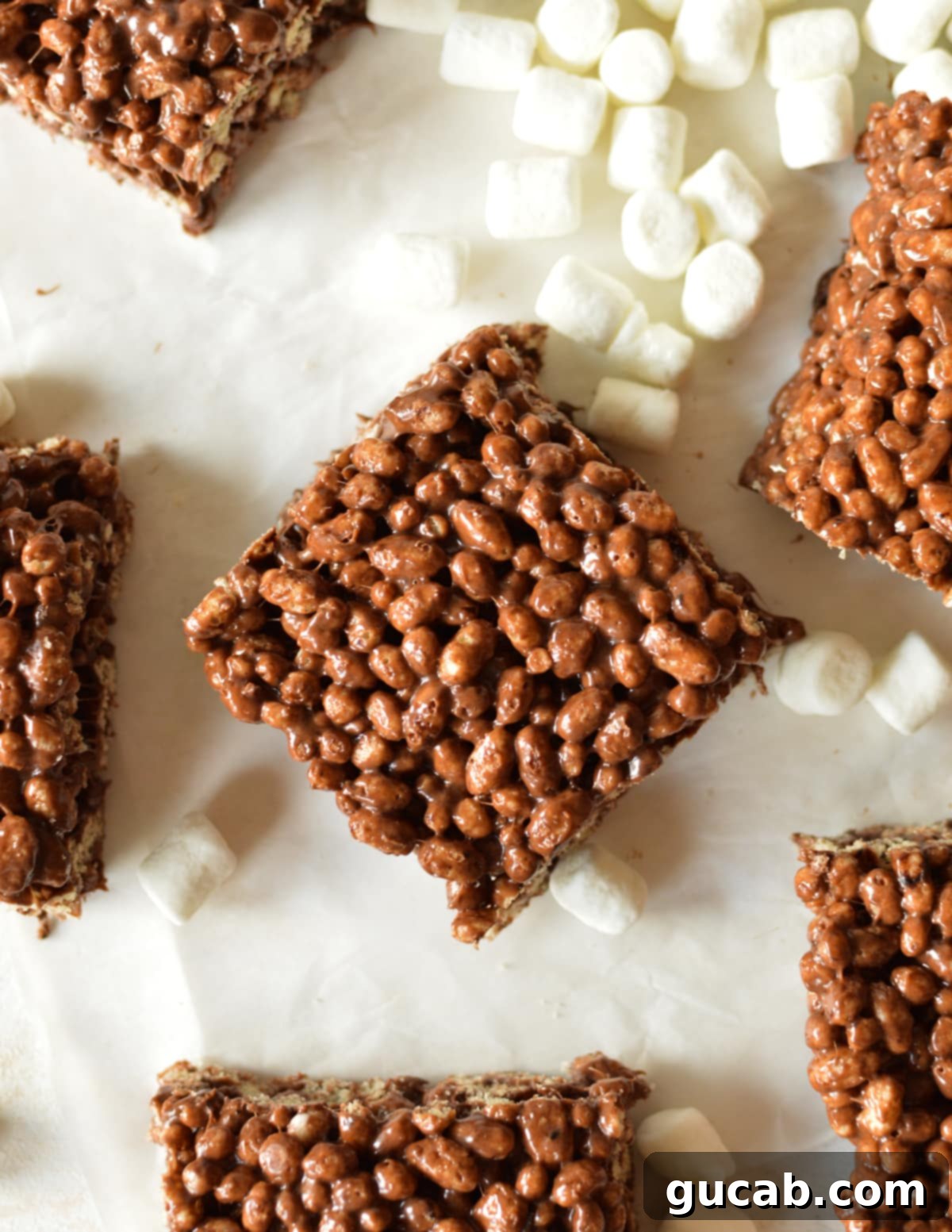 Close up of a delicious homemade chocolate protein rice crispy treat, showing its gooey texture and chocolate chunks.