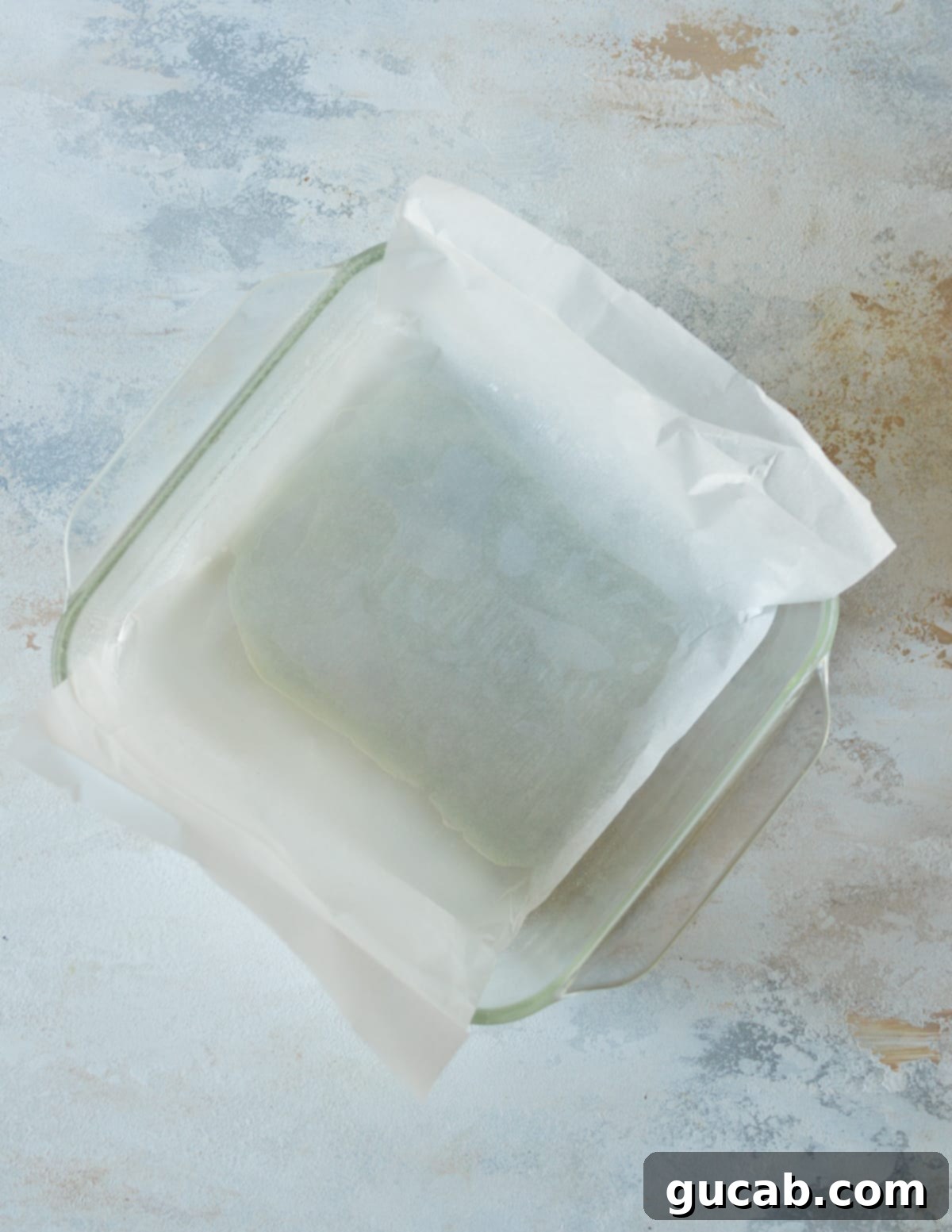 a baking dish with parchment paper in it