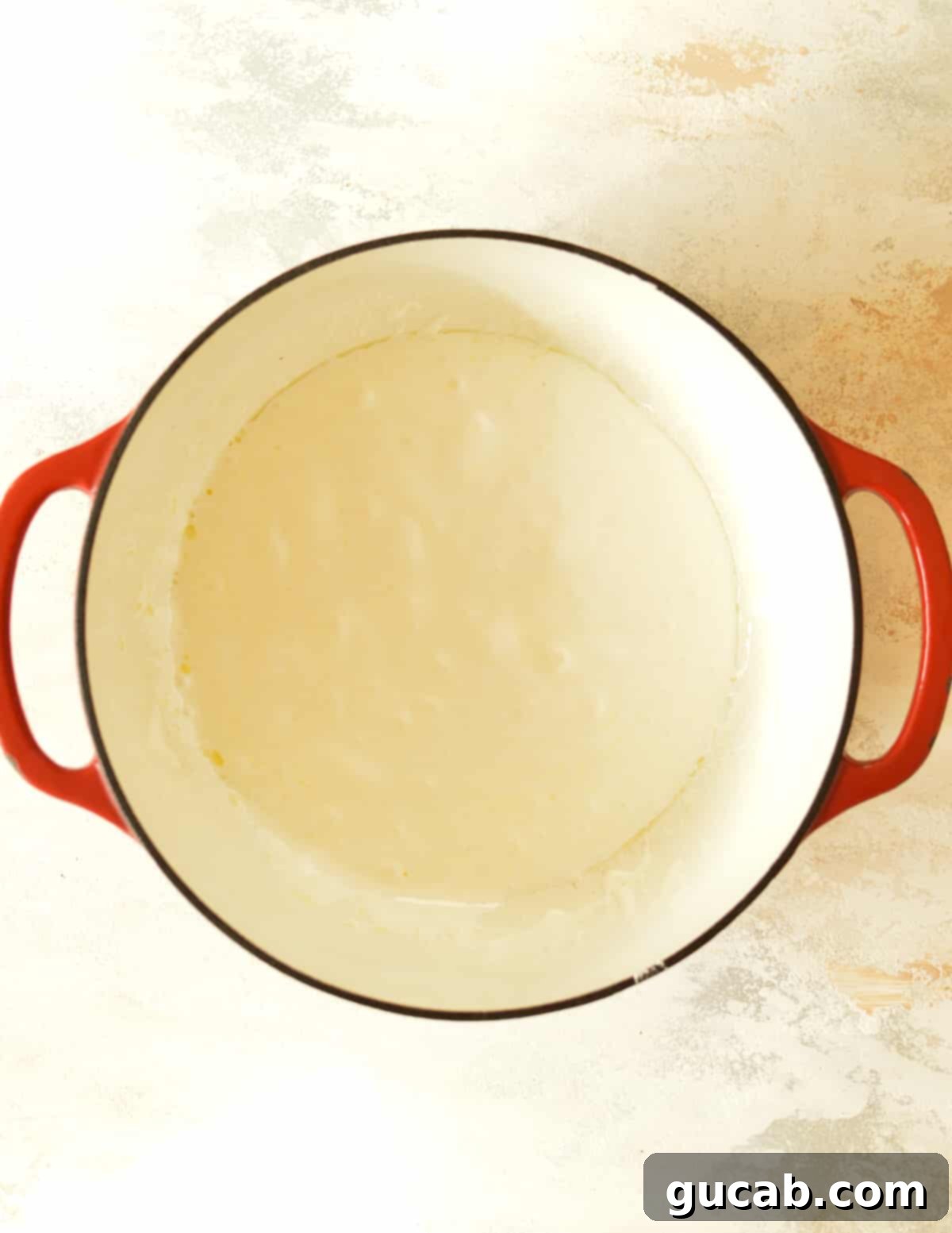 a dutch oven with melted butter and marshmallow cream