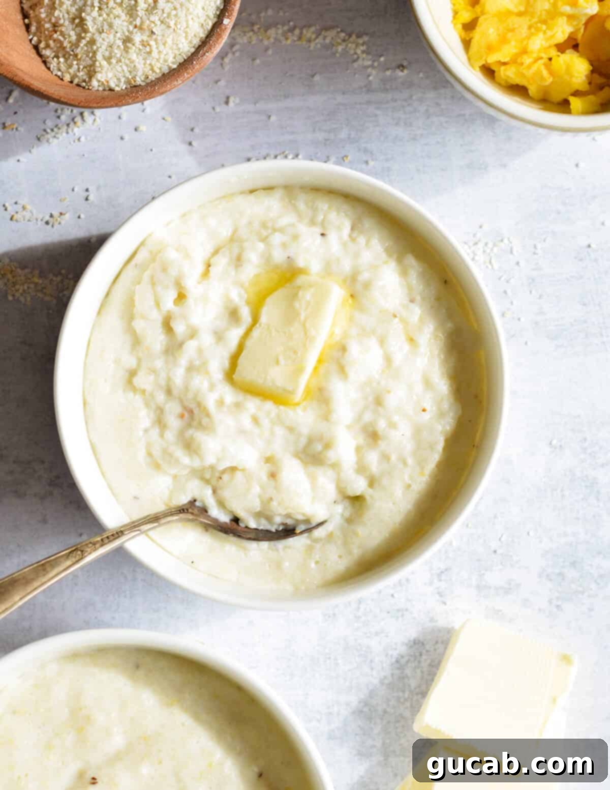Hearty Creamy Grits 2 A beautifully presented bowl of creamy grits with a melting pat of butter on top, ready to be enjoyed.