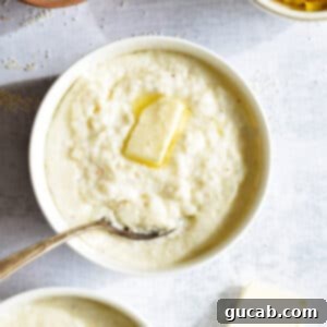 Hearty Creamy Grits 11 A bowl of creamy stoneground grits with a melting pat of butter on top, showcasing its rich texture.