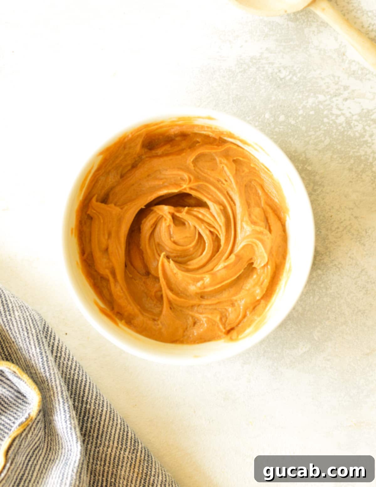 Chocolate Protein Cookie Dough 4 a bowl of peanut butter and maple syrup