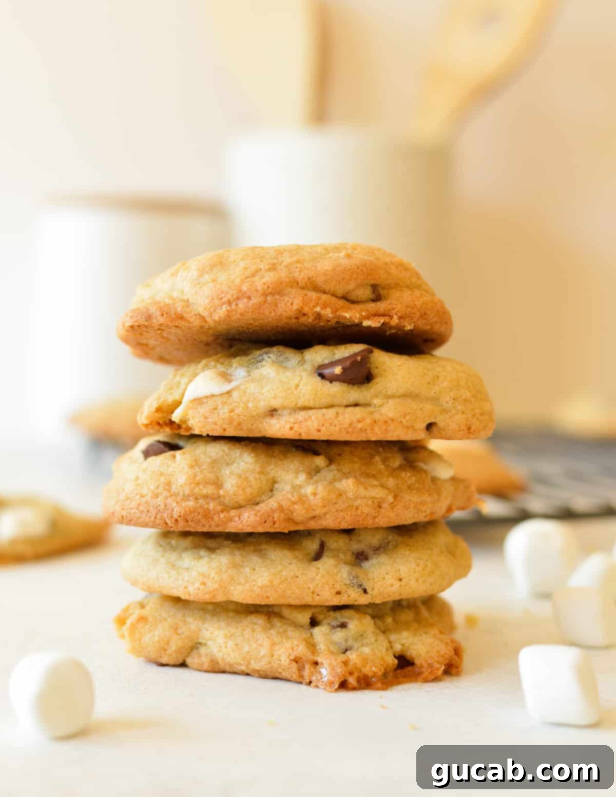 a stack of perfectly baked chocolate chip marshmallow cookies with visible melted chocolate and gooey marshmallows