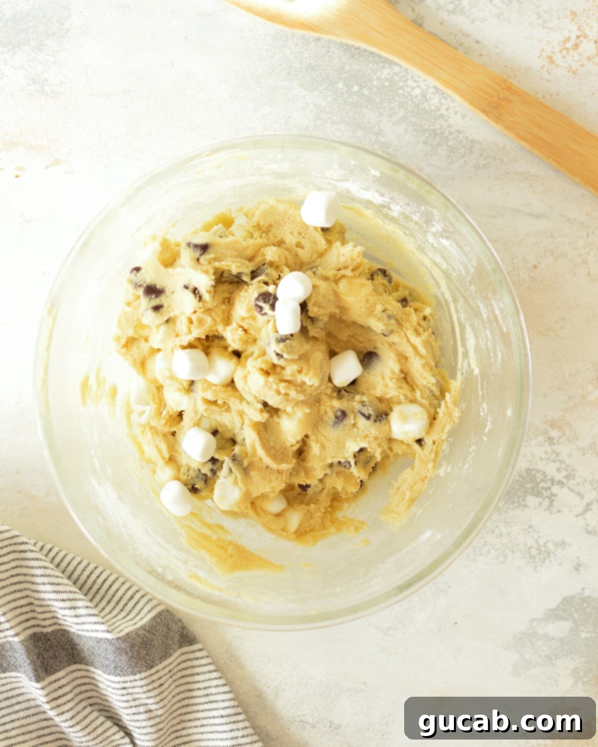 a bowl of chocolate chip marshmallow cookie dough with visible chocolate chips and mini marshmallows