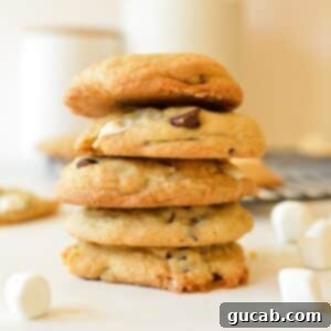 a stack of freshly baked chocolate chip marshmallow cookies, showing their soft centers and melty bits