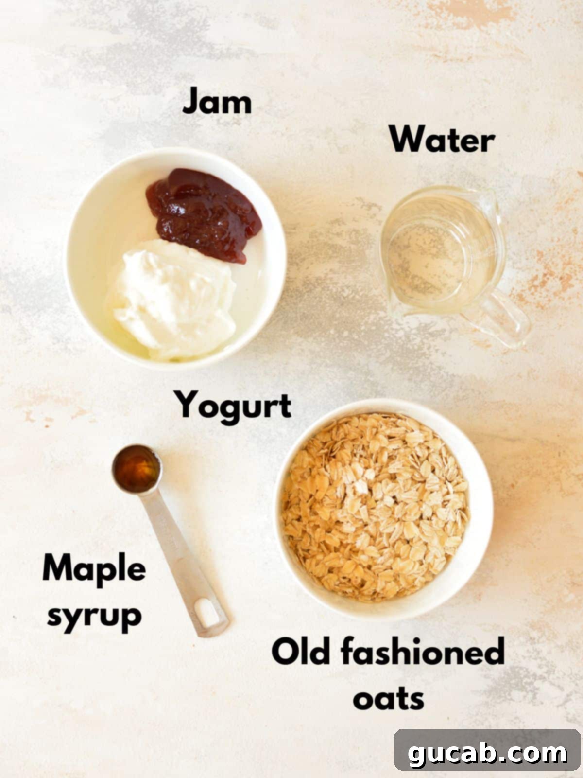 A selection of ingredients for making overnight oats, including rolled oats, a glass of water, yogurt, a jar of jam, and maple syrup.