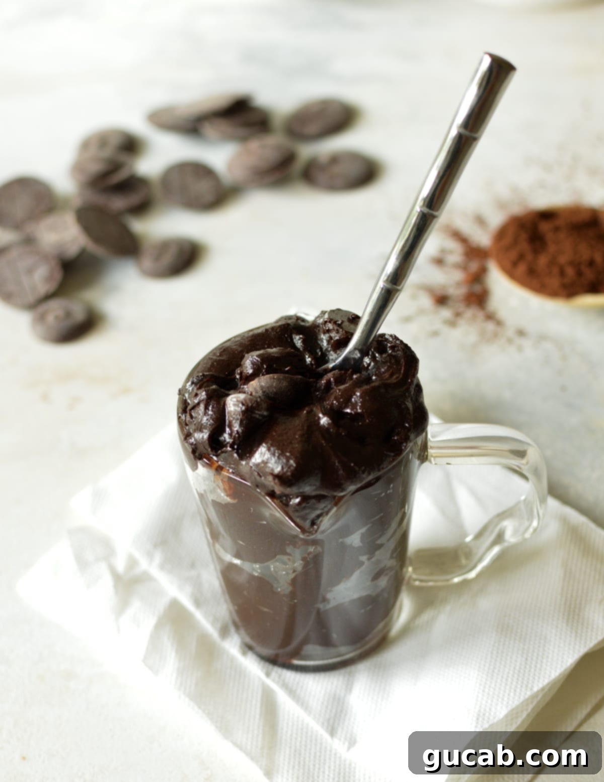 No-Bake Fudgy Brownie Indulgence 8 a cup of edible brownie batter with a spoon in it, ready to be enjoyed