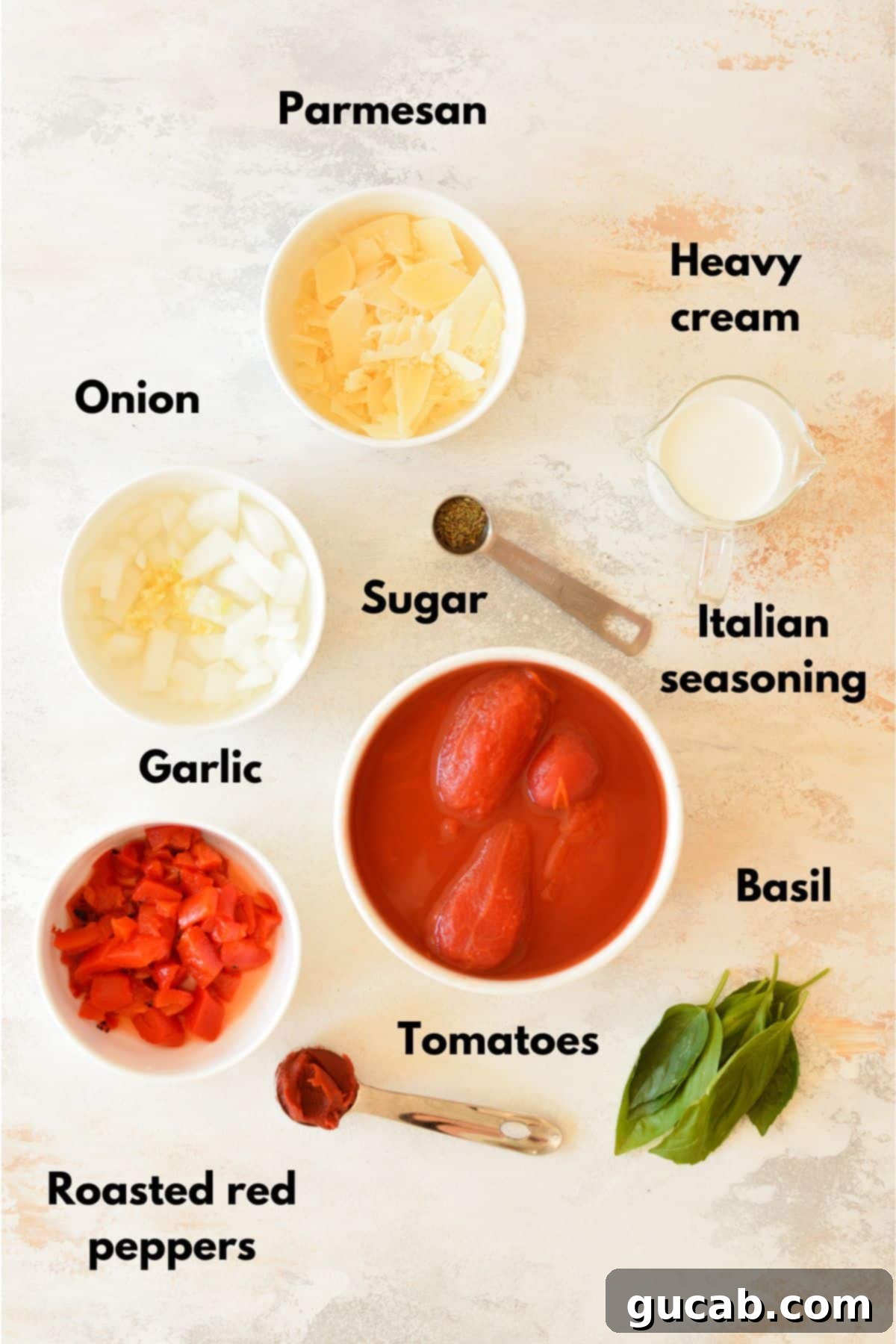 Rose Pasta 3 A selection of fresh ingredients including whole peeled tomatoes, onions, garlic, fresh basil, roasted red peppers, olive oil, heavy cream, and Parmesan cheese, ready for making pink sauce pasta.