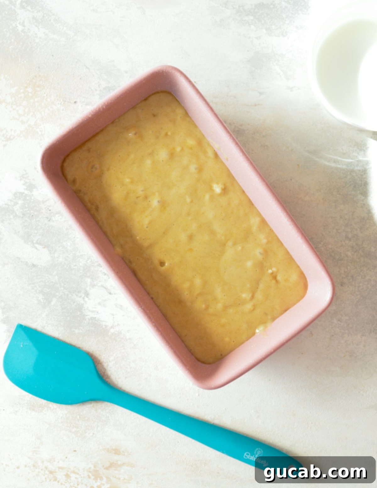 banana bread batter in a loaf pan. 