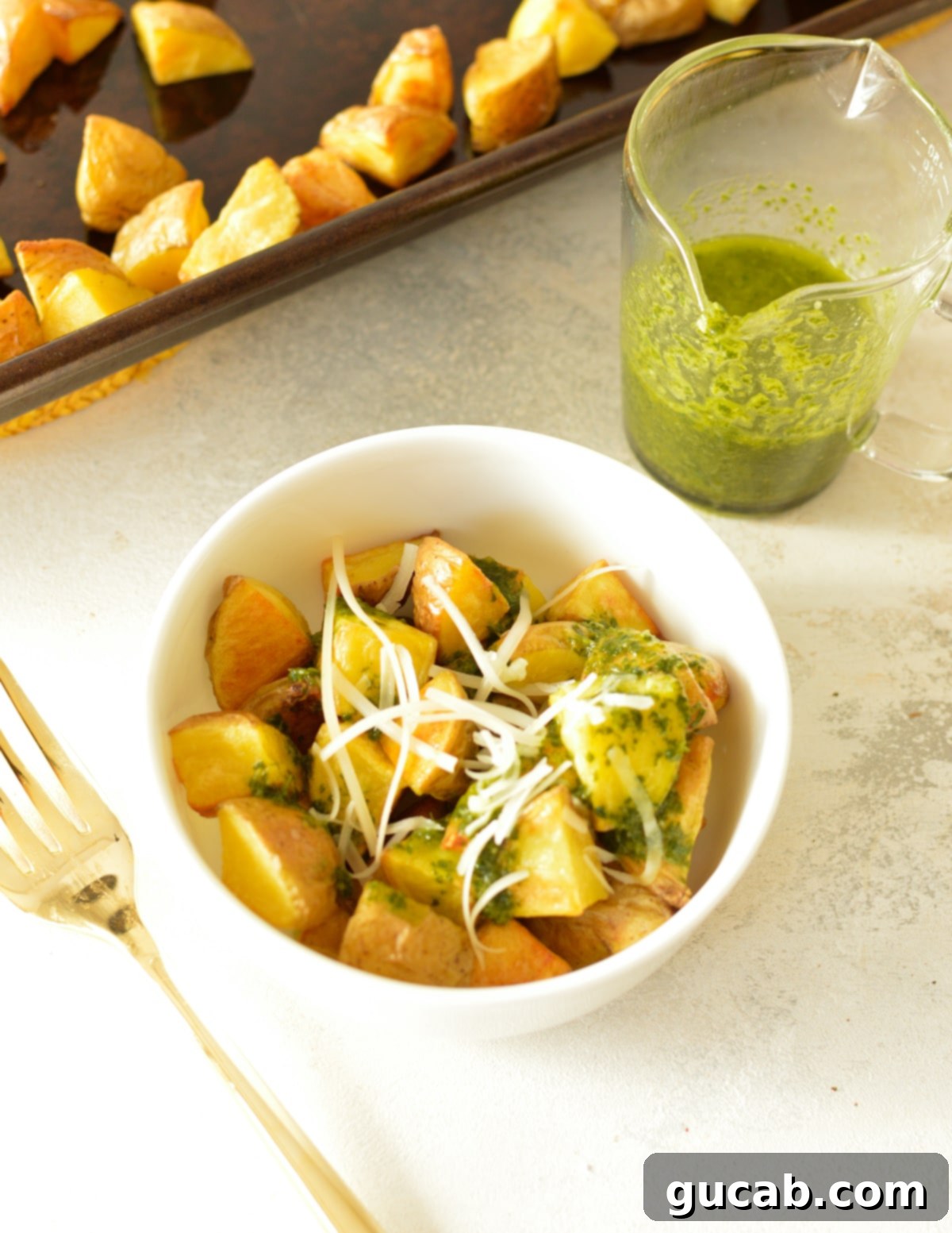 A serving bowl filled with roasted honey gold potatoes, a versatile and delicious side.