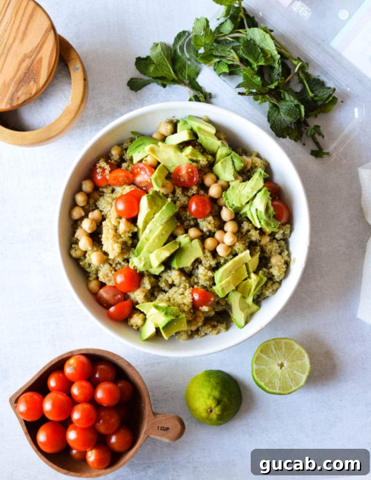 Vibrant Herb & Quinoa Power Bowl 11 a bowl of quinoa salad with chickpeas, avocado, and cherry tomatoes.