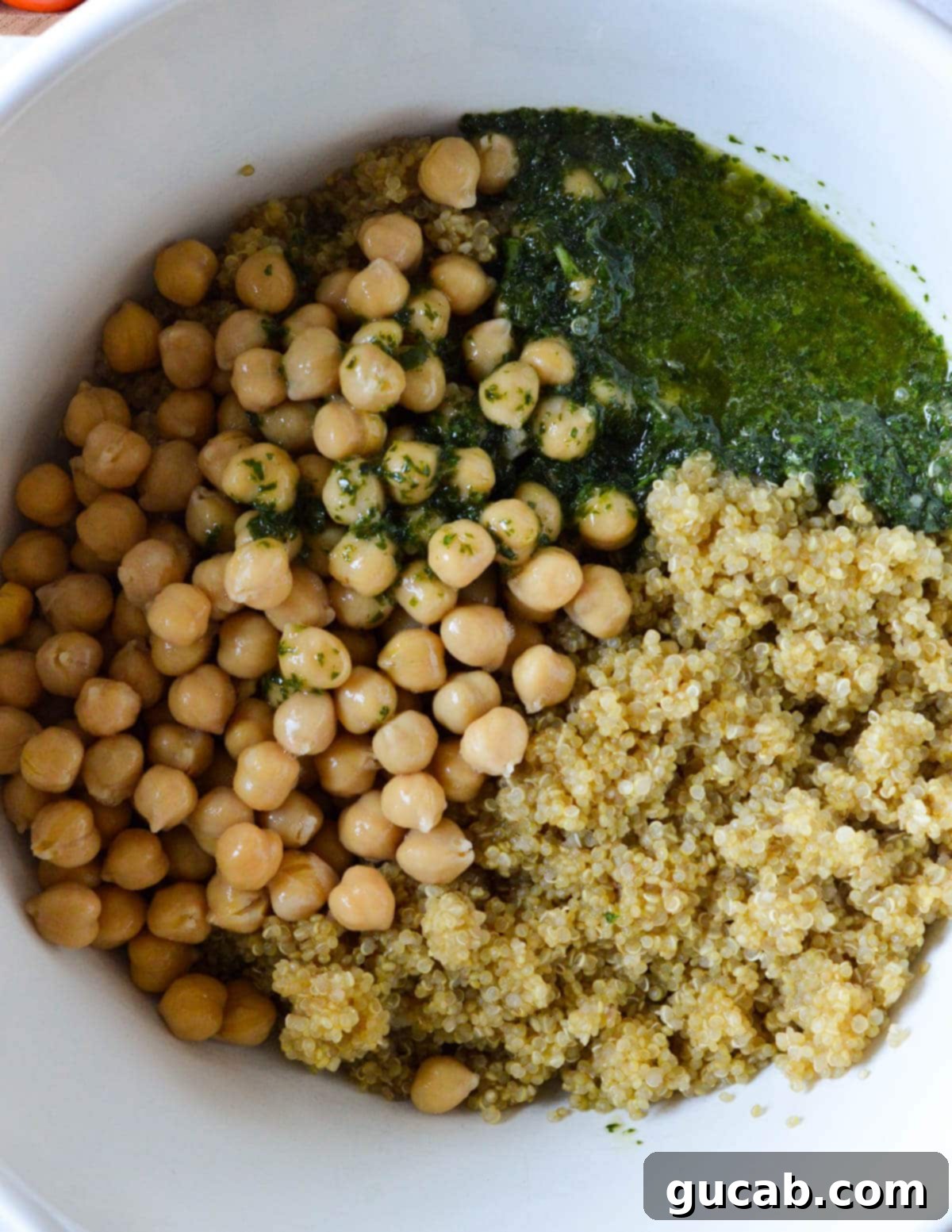 Vibrant Herb & Quinoa Power Bowl 8 herb vinaigrette, chickpeas, and cooked quinoa in a bowl.
