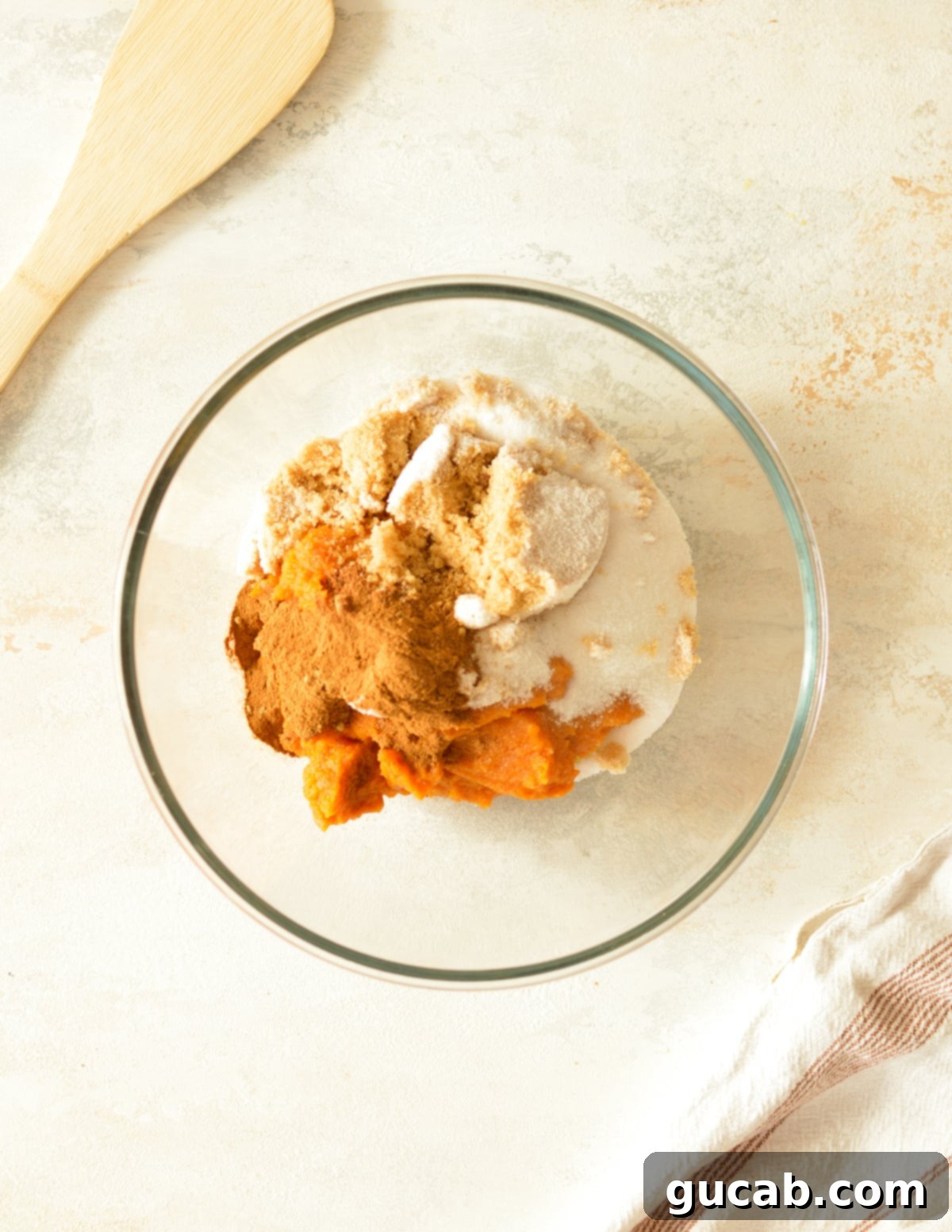 a bowl with pumpkin puree, spices, and sugar