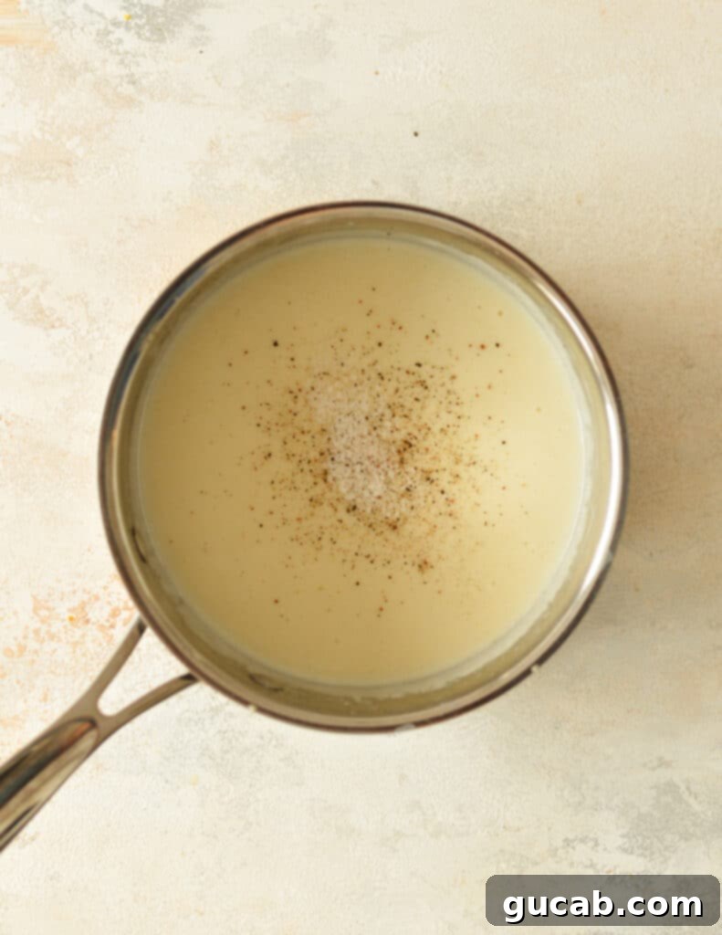 finished creamy gluten-free bechamel sauce in a saucepan