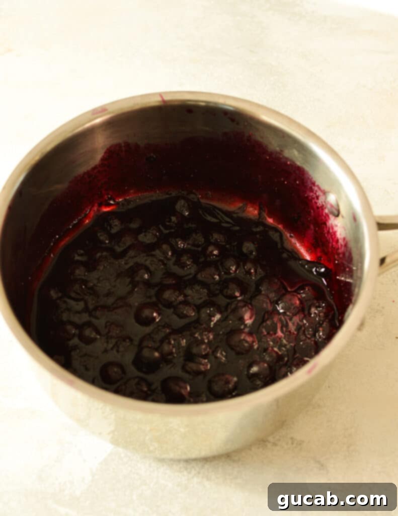 Indigo Berry Swirl 5 cooked blueberries in saucepan.