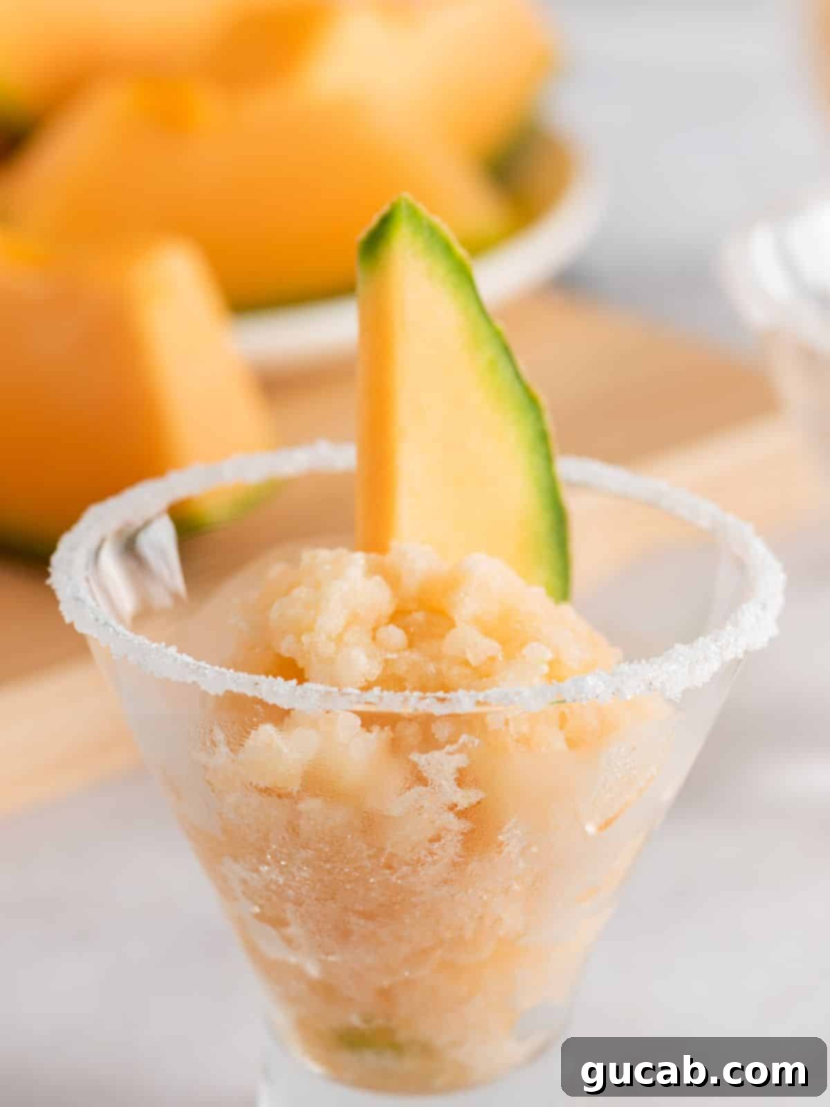 A bowl of refreshing cantaloupe granita, a frozen dessert.