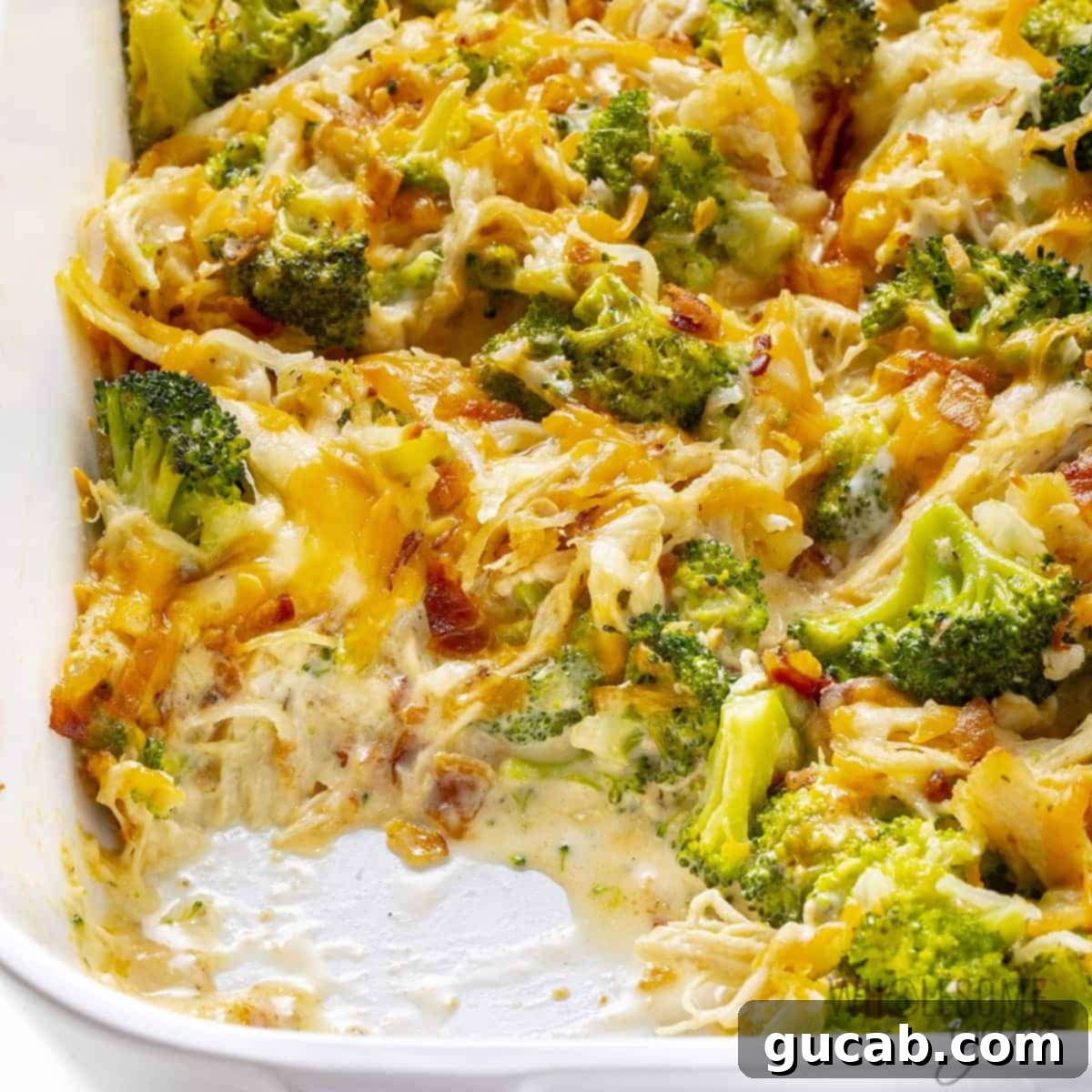 Budget-Friendly Feasts for a Crowd 11 A close-up shot of a bubbling Chicken Bacon Ranch Casserole, topped with melted cheese and crispy bacon bits.