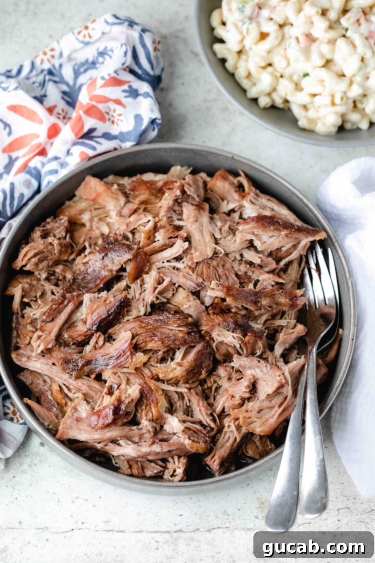 Budget-Friendly Feasts for a Crowd 5 A plate piled high with perfectly shredded Kalua pork, ready to be served.