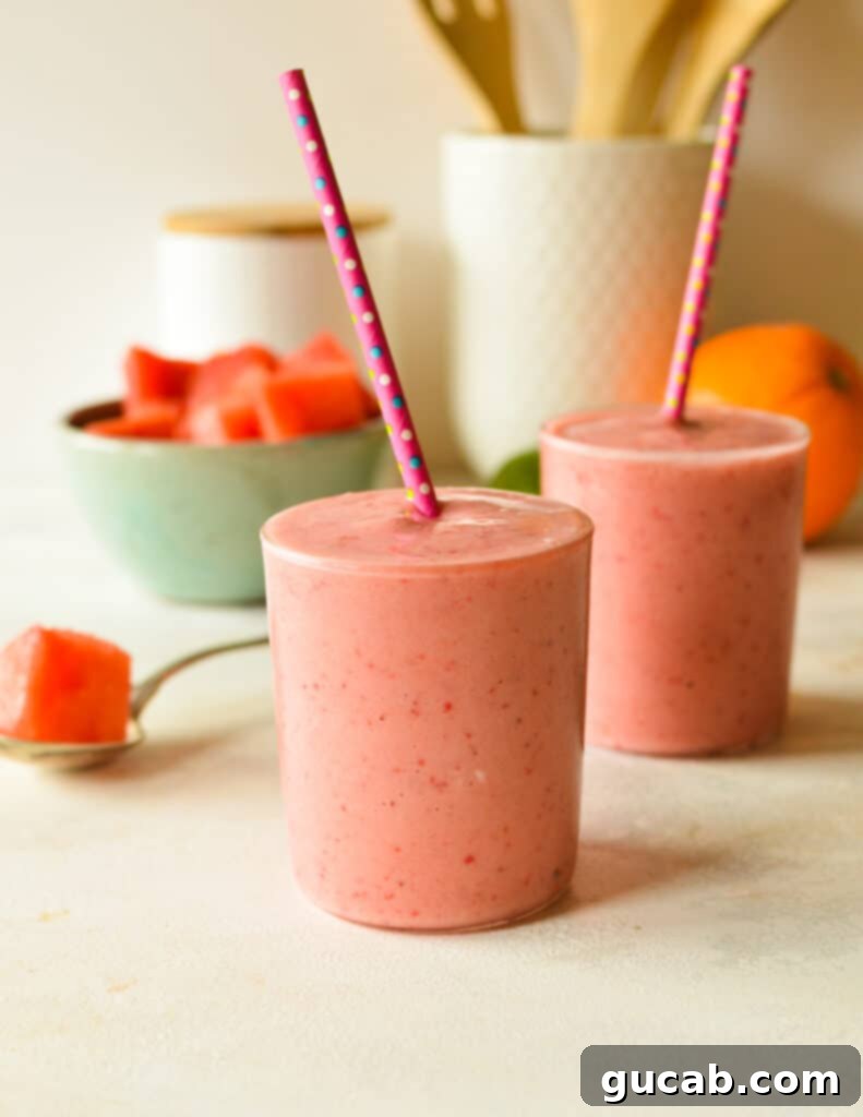 Two vibrant watermelon banana smoothies with straws, ready to be enjoyed on a sunny day.