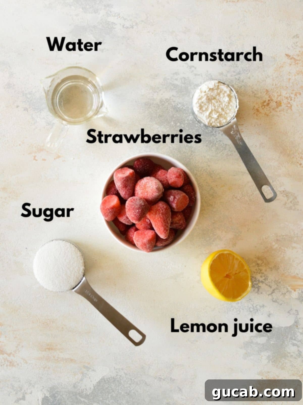 Irresistible Strawberry Cake Filling 3 All five ingredients for homemade strawberry filling laid out on a surface: fresh strawberries, water, cornstarch, sugar, and a lemon.