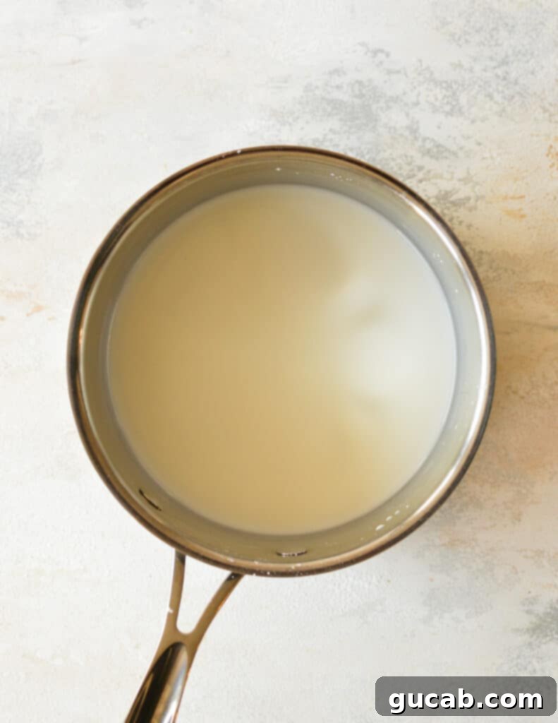 Cornstarch and water combined to form a smooth slurry in a small saucepan.