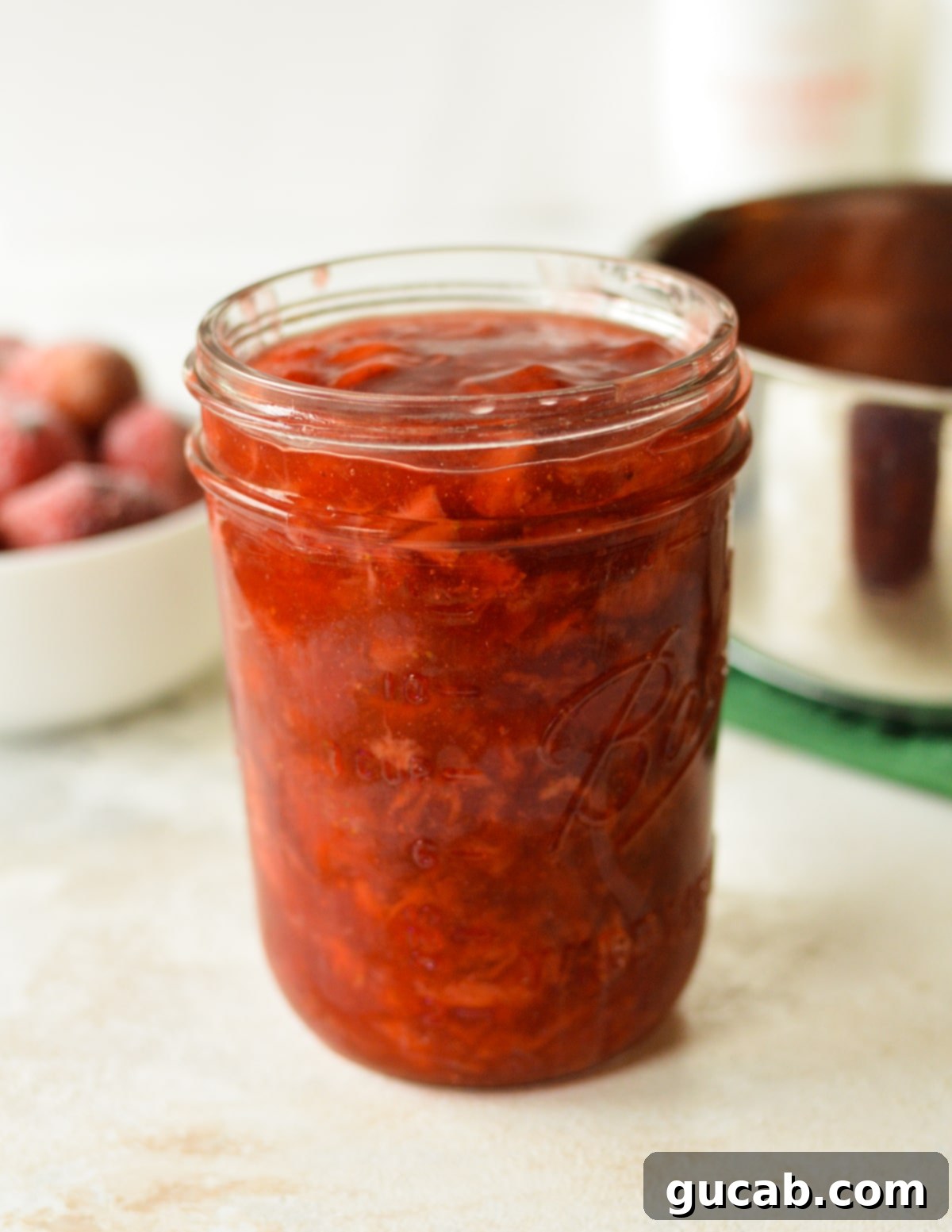 Irresistible Strawberry Cake Filling 9 A glass jar filled with the vibrant homemade strawberry cake filling.
