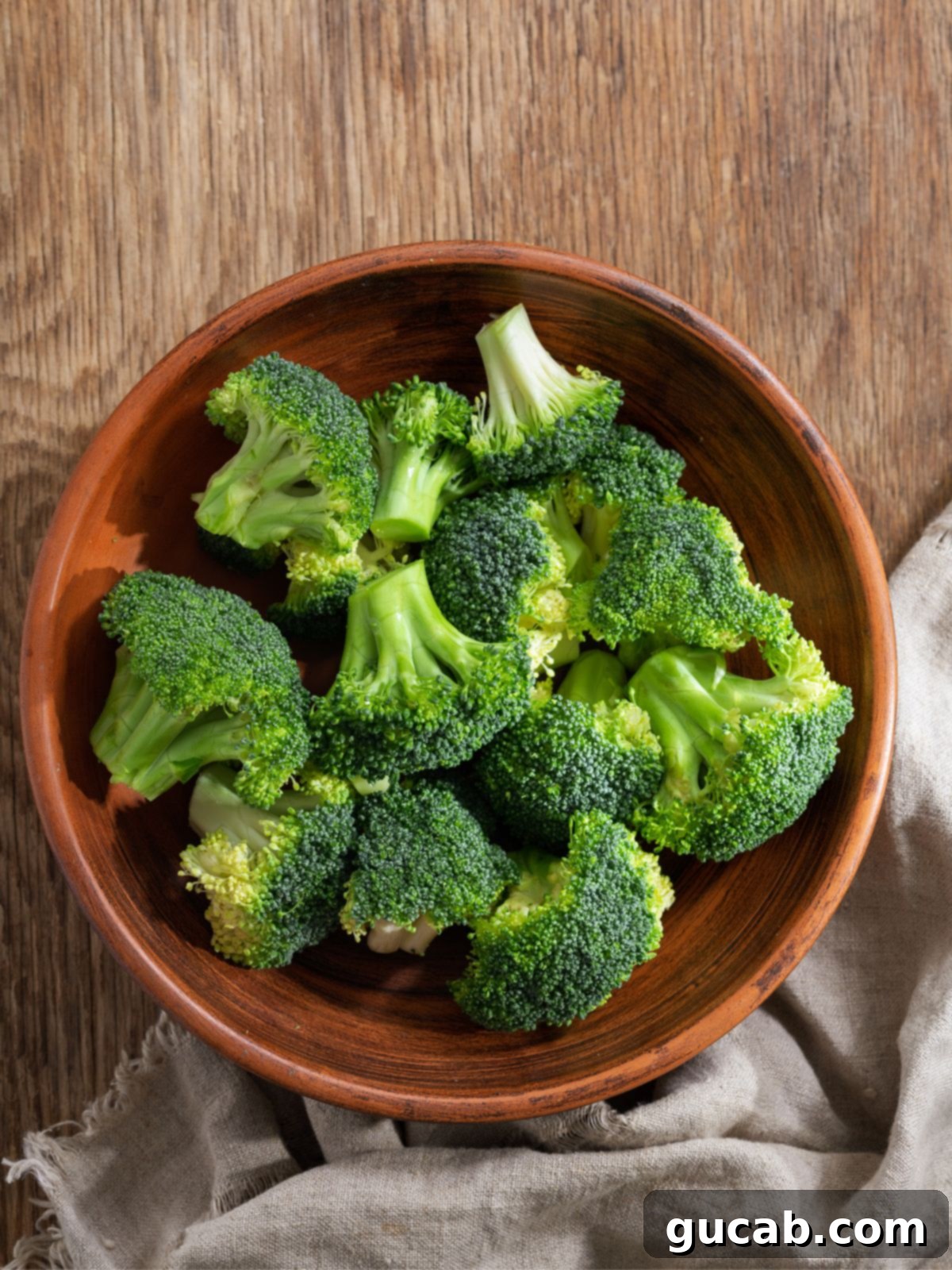 A bowl of fresh green broccoli florets, emphasizing healthy, vibrant produce.