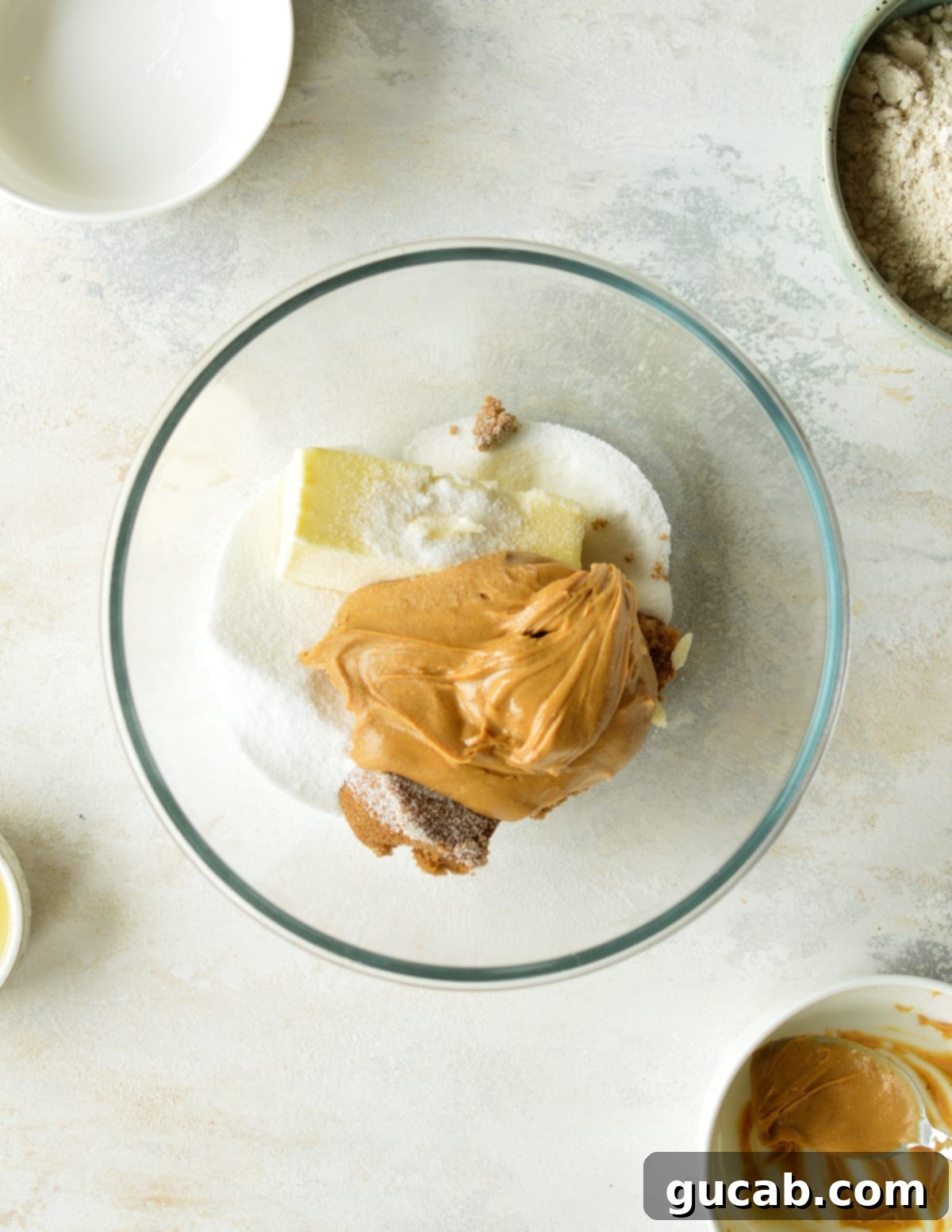 peanut butter, butter, sugar, and brown sugar in a bowl, ready to be creamed.