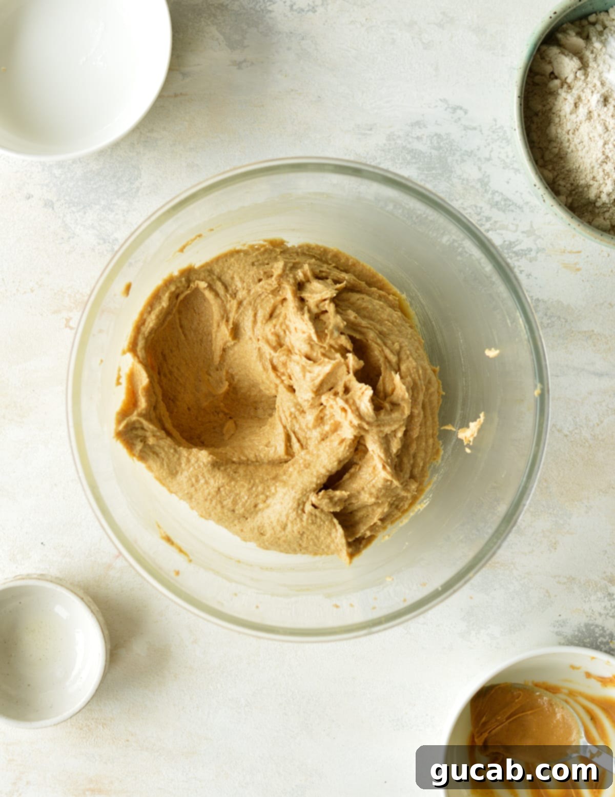 smooth peanut butter cookie dough in a mixing bowl after egg has been incorporated.