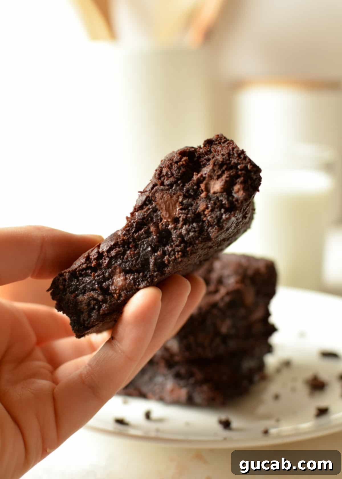 Effortless Fudgy One Bowl Gluten Free Brownies 8 hand holding a gluten free fudge brownie