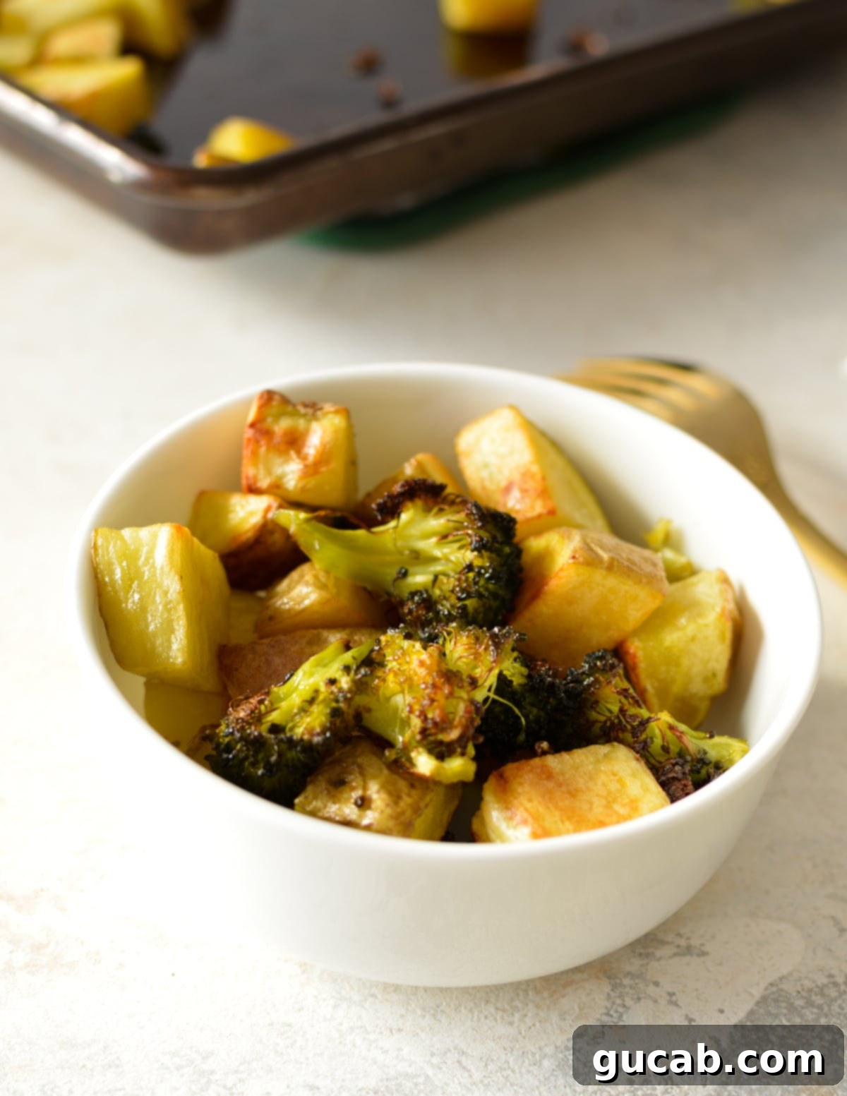 a bowl of roasted potatoes and broccoli.