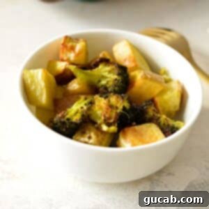 a bowl of roasted potatoes and broccoli.